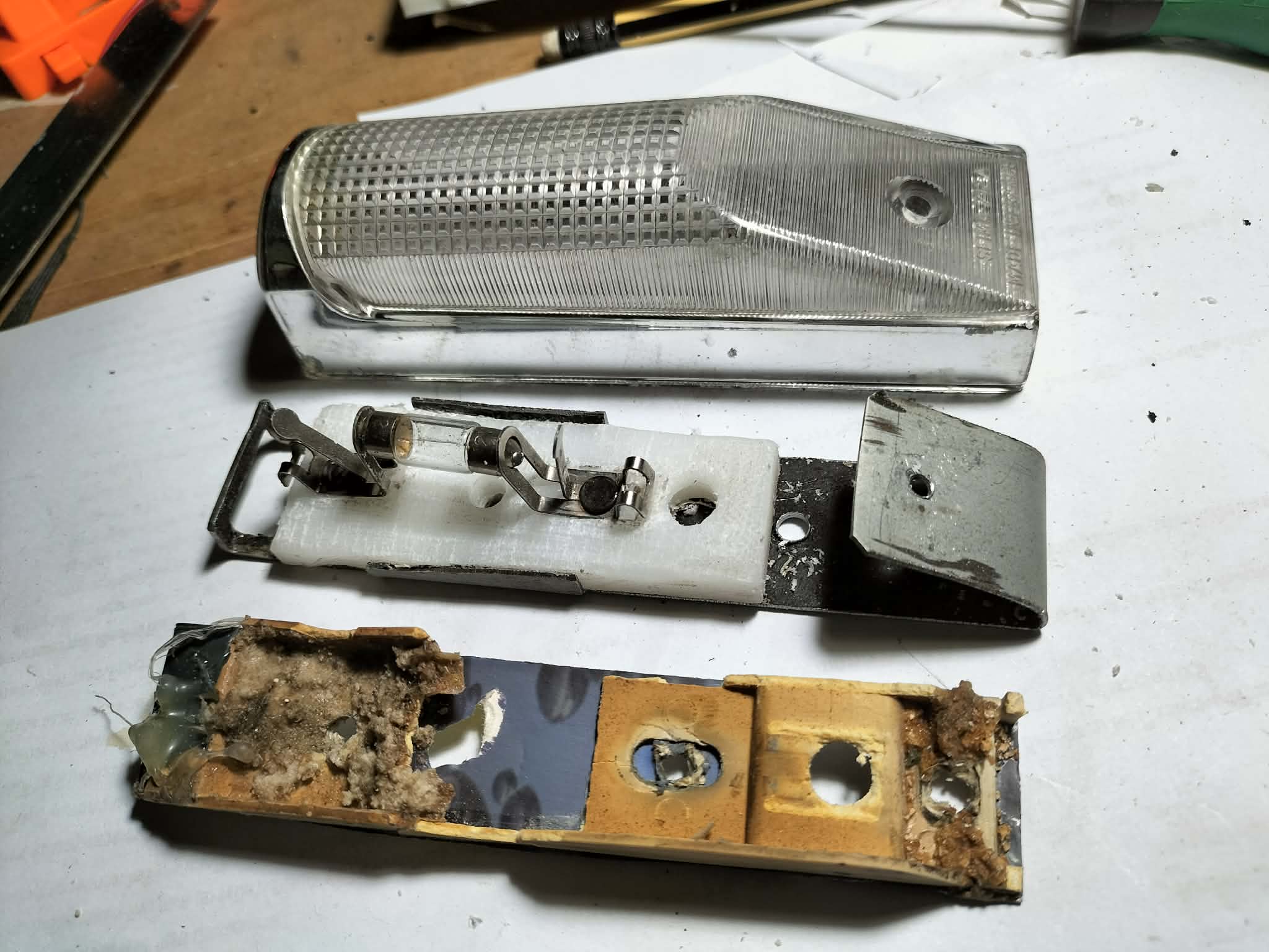 Redesign old plastic lamp housing into folding metal sheet with insulator